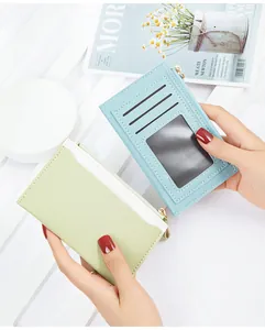 Detailed view of women's PU leather card holder featuring card slots and clear ID window