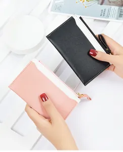 Detail of pink and black PU leather card holders with contrast stitching and zipper