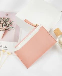 Macro detail of a pink and white PU leather patchwork zipper coin purse for women