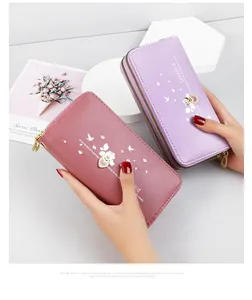 Close-up view of elegant mauve and purple long wallets with heart charm details