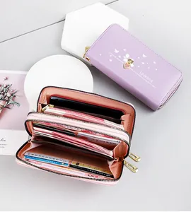 Close-up showing the large interior capacity and card slots of the pink long wallet