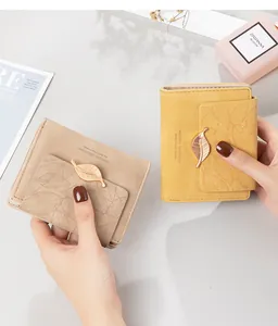 Detailed view of retro matte women's short wallets with elegant metal leaf clasps.