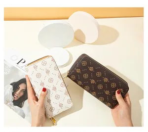 Detailed view of a double-layer printed long clutch bag in white and dark brown finishes.