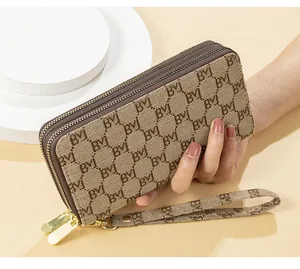 Detailed view of women's long double zipper clutch wallet featuring classic letter pattern