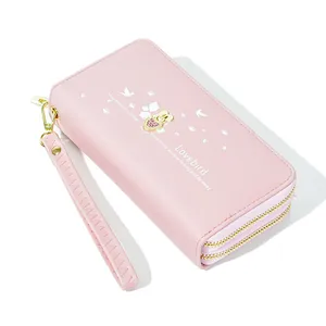 Pink long wallet with heart print and wrist strap, large capacity design.