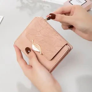 Elegant pink frosted short wallet for women featuring a golden leaf clasp design.