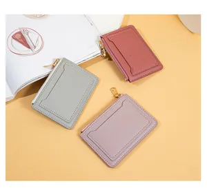 Collection of three minimalist zipper card holders in pastel colors with front card slot