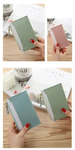 Close-up detail of crocodile pattern slim card holder wallets in various pastel colors