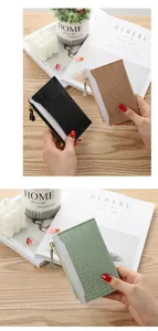 Detailed view of crocodile textured small women's wallets in black, beige and mint green colors