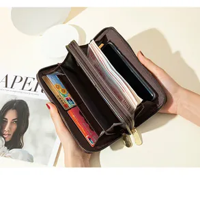 Detailed interior of a brown double-zipper long wallet showing cards and cash capacity