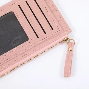Premium pink crocodile pattern card holder wallet with multiple card slots and zipper closure.