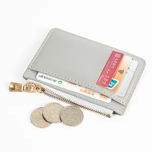Slim gray leather card holder with zipper pocket and multiple slots for coins and cards