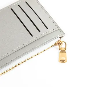 Grey minimalist short wallet featuring a gold zipper and multiple card slots for women