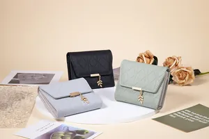 Elegant women's trifold wallets in multiple colors featuring a gold leaf pendant detail.