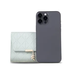 Mint green lattice trifold women's wallet with leaf pendant next to a smartphone