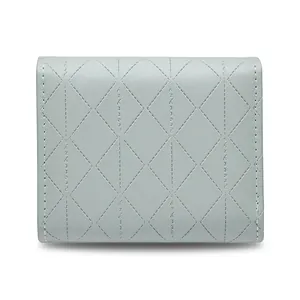Macro view of light blue quilted leather wallet with diamond stitching and trifold design