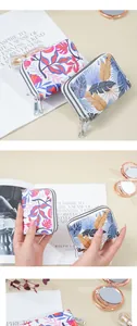 Detailed view of the vibrant leaf print on this stylish double zipper card holder wallet