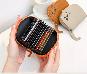 Detailed view of cute cat-shaped leather card holder with multi-slot accordion design.