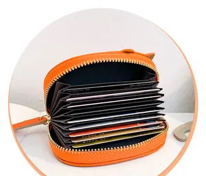 Detailed view of the internal multi-slot structure of an orange accordion-style card wallet