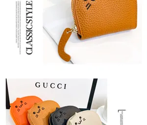 Close-up of cute cat-shaped leather card holder showing high quality litchi grain texture