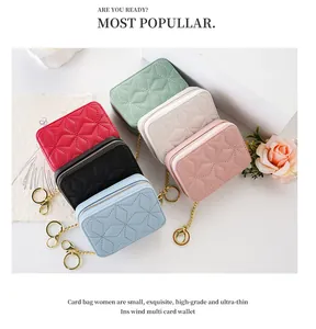 Detailed view of quilted mini makeup bags in various pastel colors with gold keychains