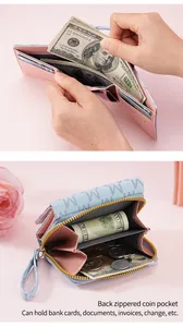 Detailed view of the zippered coin pocket and bill compartment in a women's wallet.