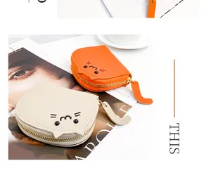 Detailed view of cute cat-shaped faux leather coin purses with tail zipper pulls