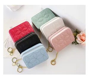 Small portable quilted cosmetic bags in multiple colors with star embroidery and keychain