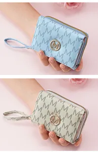 Detailed view of women's tri-fold short wallet featuring stylish letter M monogram pattern