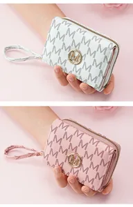 Detail of women's three-fold short wallet with letter pattern and metal logo