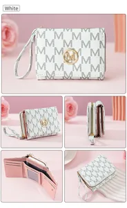Detailed view of white tri-fold wallet with M pattern and pink interior card slots.