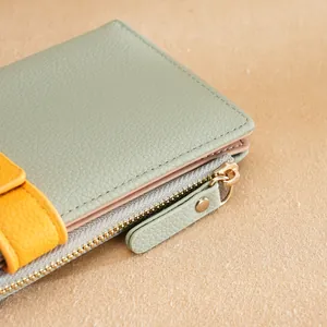 Stylish color-blocked women's long wallet in mint green and yellow with pebbled leather texture
