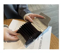 Internal detail of a silver leather card holder featuring large capacity accordion slots