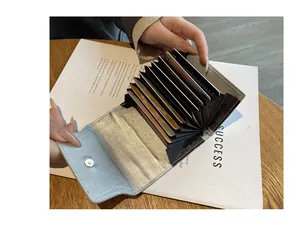 Close-up detail of a silver leather card holder with high-capacity accordion slots.