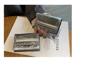 Detail showing the shiny silver metallic texture of the minimalist leather card holder
