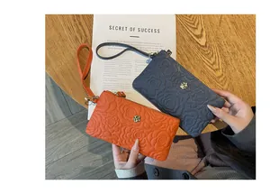 Pochette en cuir pour femme avec motif floral embossé, dragonne et fermeture éclair