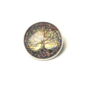 Detail view of a vintage Tree of Life glass cabochon brooch with vibrant mosaic patterns