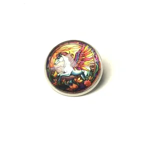 Detailed view of a circular stained-glass style Pegasus brooch with silver frame