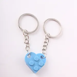 Detailed view of blue heart building block keychains joined together for couples.