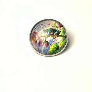 Close-up of tree frog glass cabochon brooch with vibrant stained-glass art detail