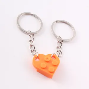 Detailed view of orange building block heart-shaped keychain pair for couples DIY gift