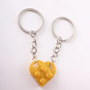 Detailed view of yellow heart-shaped interlocking building block keychain for couples