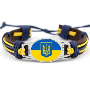 Handwoven leather bracelet featuring the Ukraine flag and trident national emblem motif