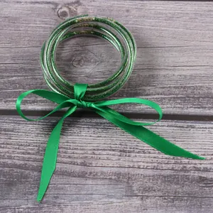 Stylish green glitter silicone bangles set decorated with a matching satin ribbon bow detail