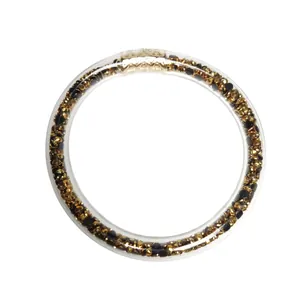 Pulsera rígida de PVC transparente 9mm con incrustaciones de piedras doradas y negras