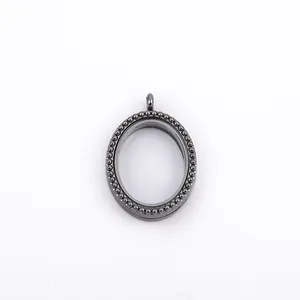 Detailed view of an oval gunmetal floating locket with a beaded bezel design.