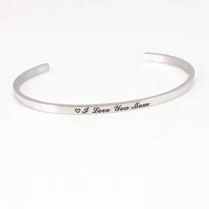 Close-up detail of silver stainless steel cuff bracelet with I Love You Mom engraving