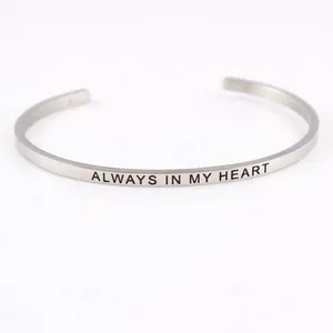 Detailed macro view of a silver stainless steel cuff bangle with Always in My Heart