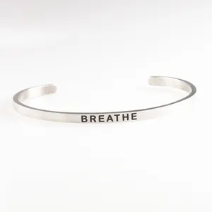 Minimalist silver stainless steel open bangle engraved with BREATHE message