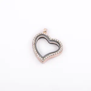 Detailed close-up of a rose gold heart-shaped floating locket with rhinestones